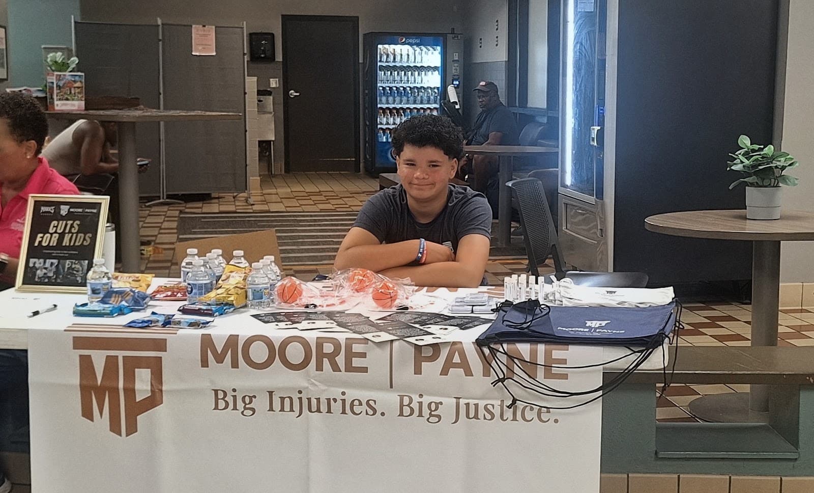 Moore Payne Law Cuts for Kids table at YMCA Healthy Family Day