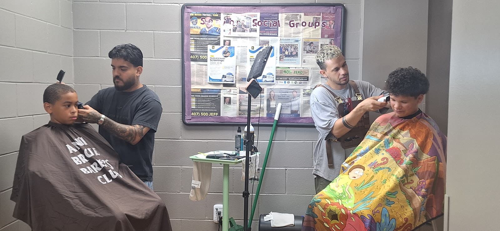 Makk's barbers giving children free haircuts at the Downtown Orlando YMCA